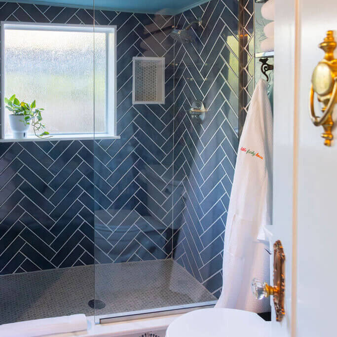 Blue Bath with herringbone tiles in shower